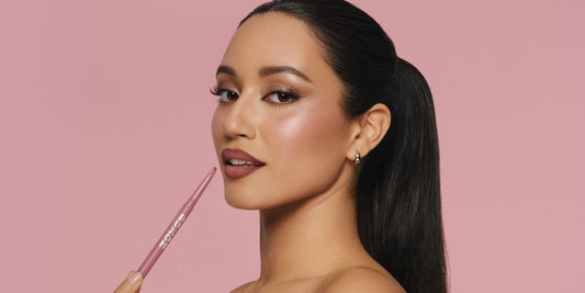 Model applying Power Line Plumping Lip Liner in Dangerous Dolly, our best selling mauve shade which is cool toned