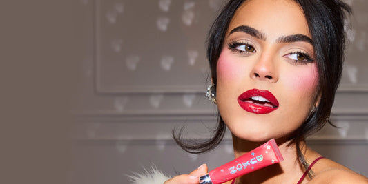 Model posing with BUXOM lip gloss