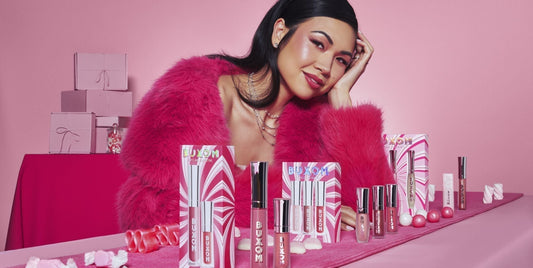Model wearing a holiday looks. Holiday product collection on the table in front.
