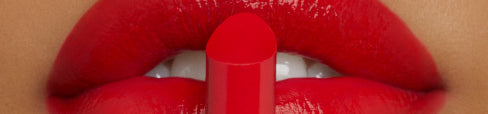 A pair of red lips with a red lip product in front of them.